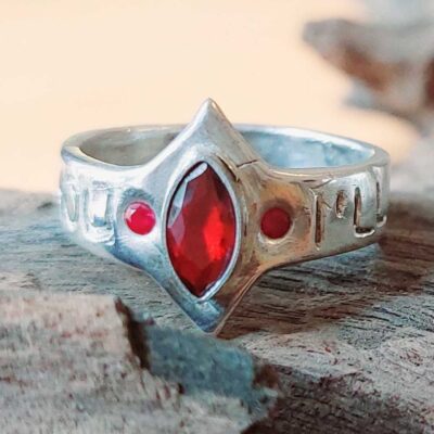 Handmade silver ring created in a creative jewelry workshop in Basel, featuring one marquise-shaped red zirconia and two smaller round red zirconias, crafted by a participant