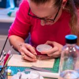 One participant carefully shaping a silver clay jewelry piece during a creative workshop in Basel – inspiring team event and creative group activity.
