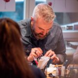 Man designs his own silver ring in a creative jewelry workshop Basel