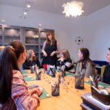 Participants sit around the table listening to the instructor – creative teambuilding activity and team event in Basel.