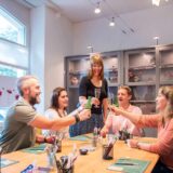 Five people enjoying an apéro in the atelier – creative team activity with silver clay and jewelry making.